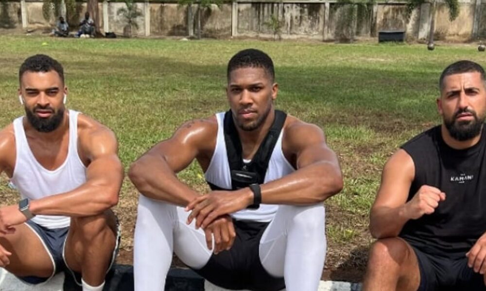 Anthony Joshua looking somber during public appearance following team tragedy