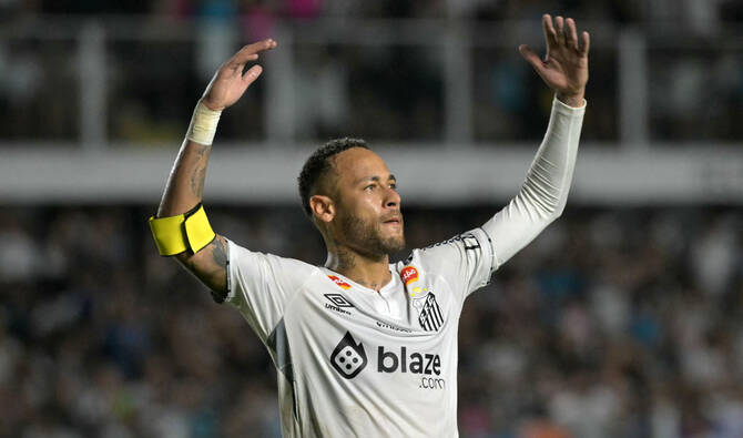 Neymar celebrating in a Santos shirt after signing a contract extension