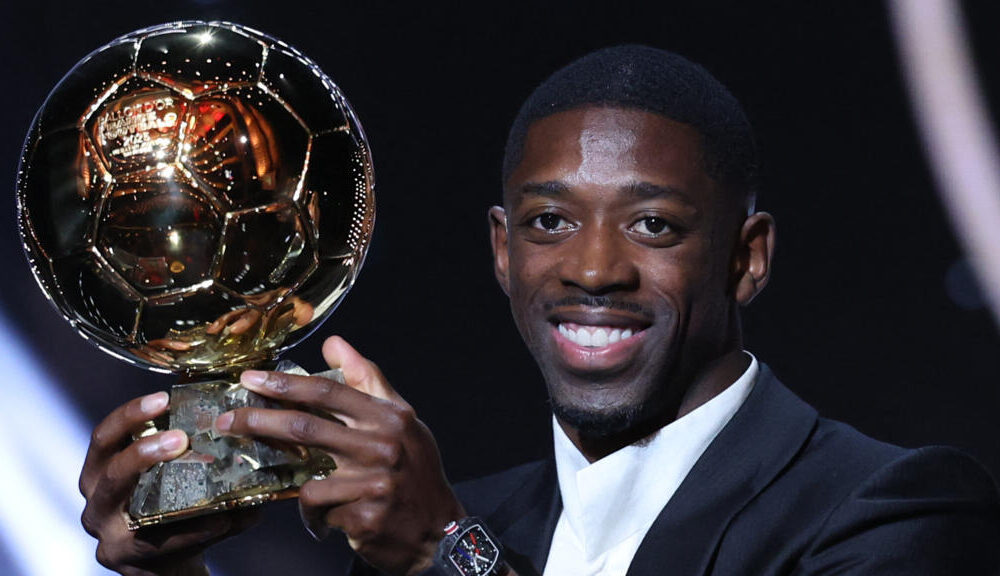 Ousmane Dembele holding the Ballon d’Or in PSG colours