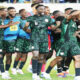 Super Eagles players celebrating on the pitch after AFCON 2025