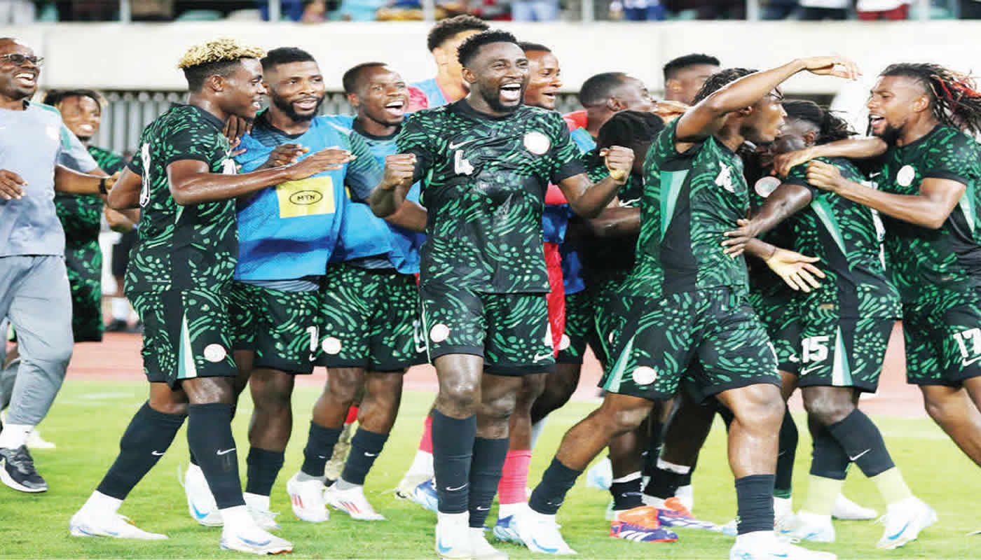 Super Eagles players celebrating on the pitch after AFCON 2025