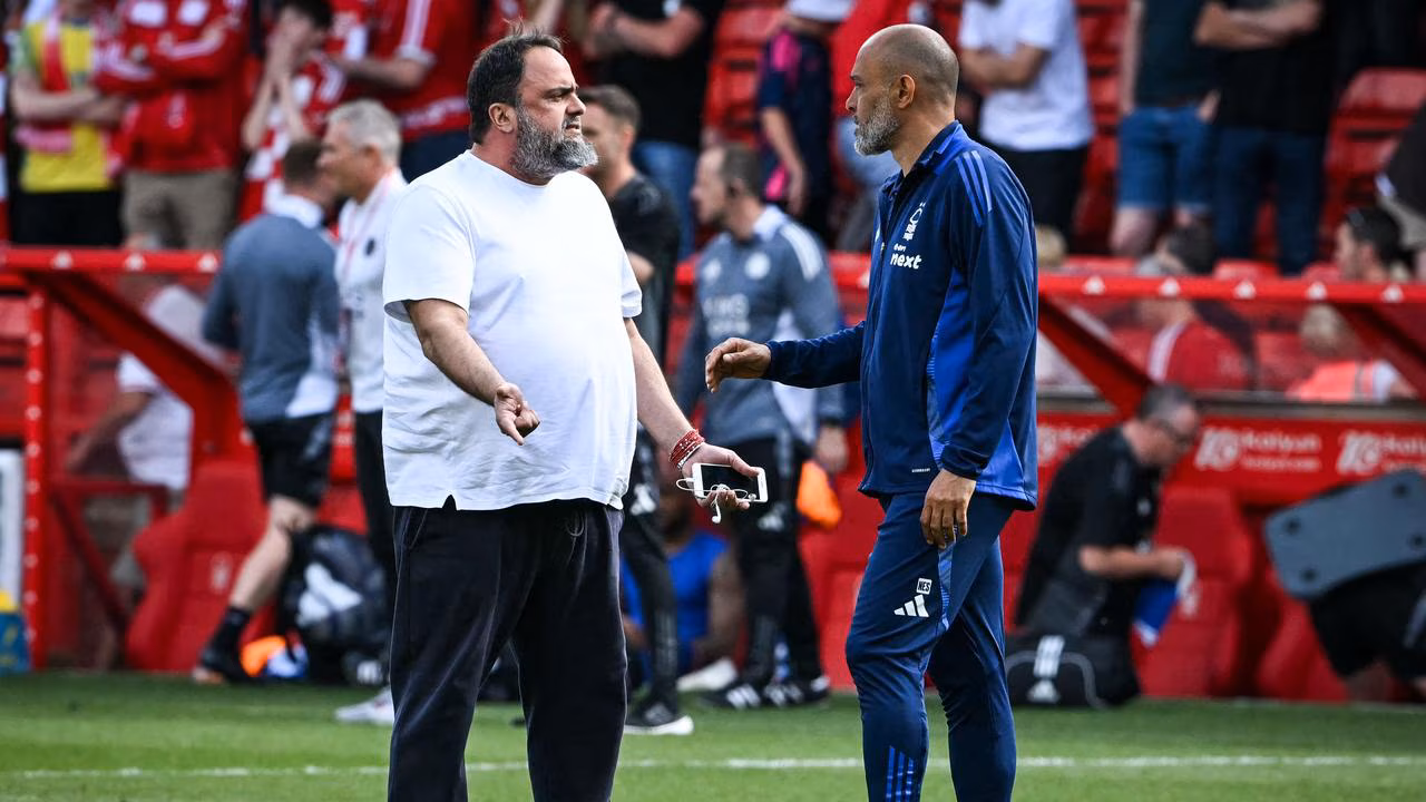 Evangelos Marinakis interacting with Nottingham Forest players on the pitch