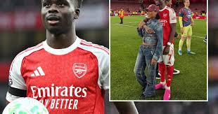 Bukayo Saka embracing fiancée Tolami Benson during Arsenal’s Premier League title celebrations.