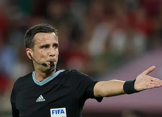 A FIFA referee explaining new football laws ahead of the 2026 FIFA World Cup.