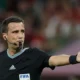 A FIFA referee explaining new football laws ahead of the 2026 FIFA World Cup.